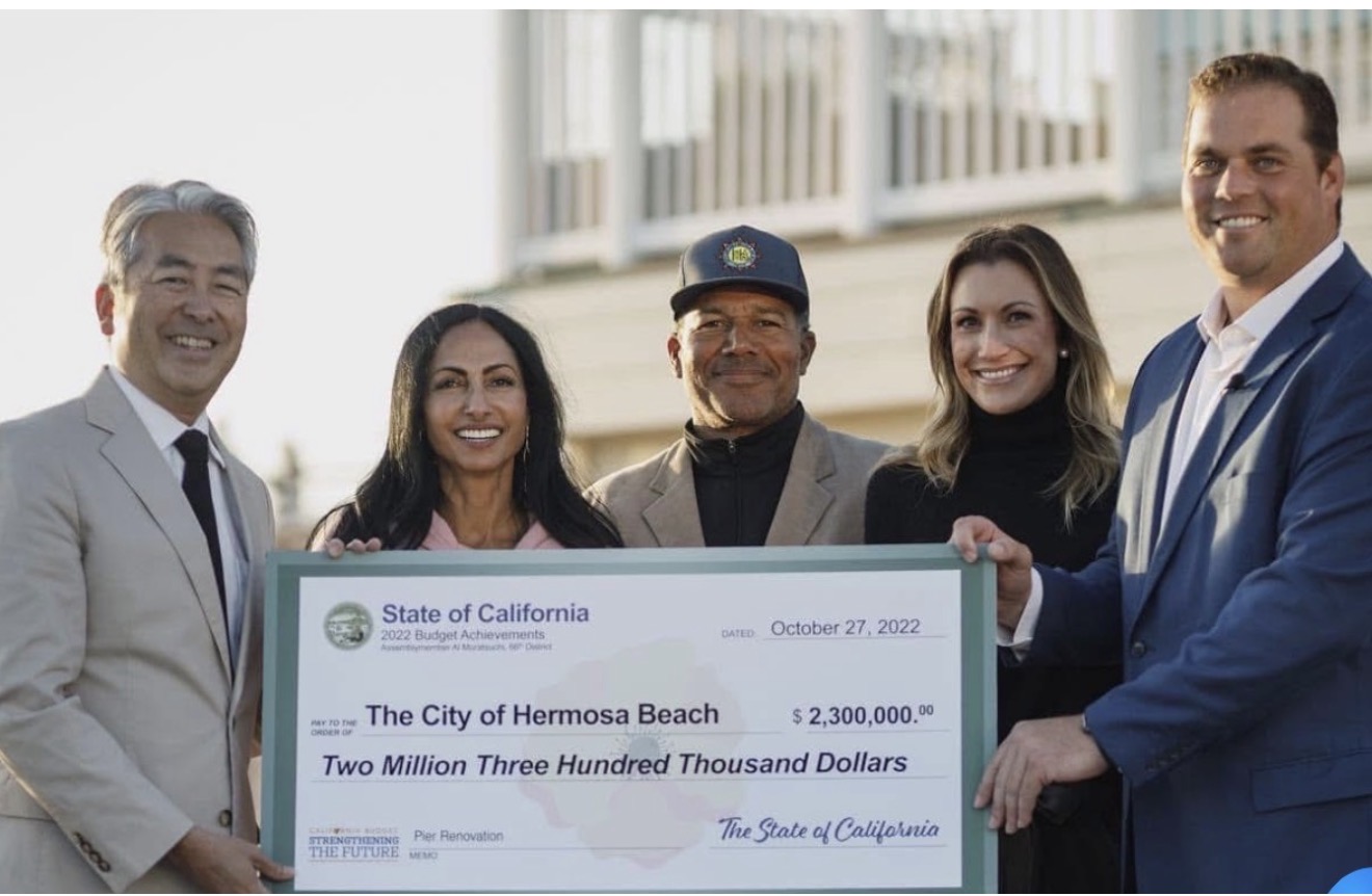 Ray Jackson and others holding an oversized $2.3 million check from the State of California.